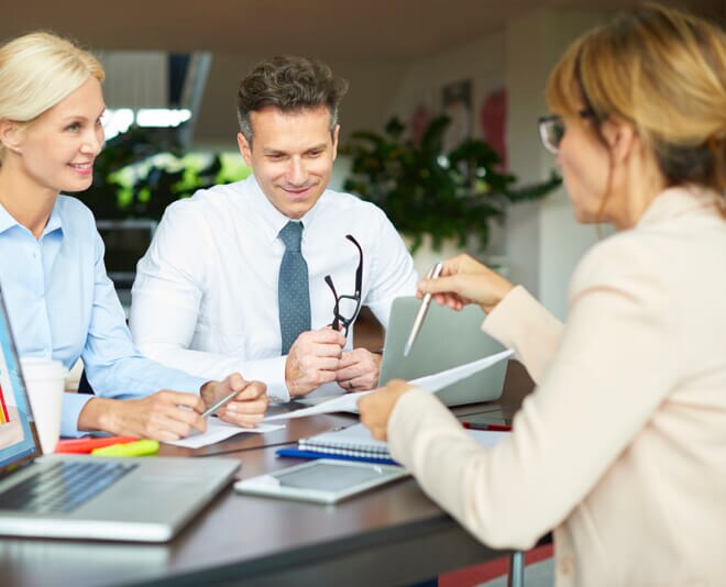 Woman consults with two customers on security solutions Woman consults with two customers on security solutions