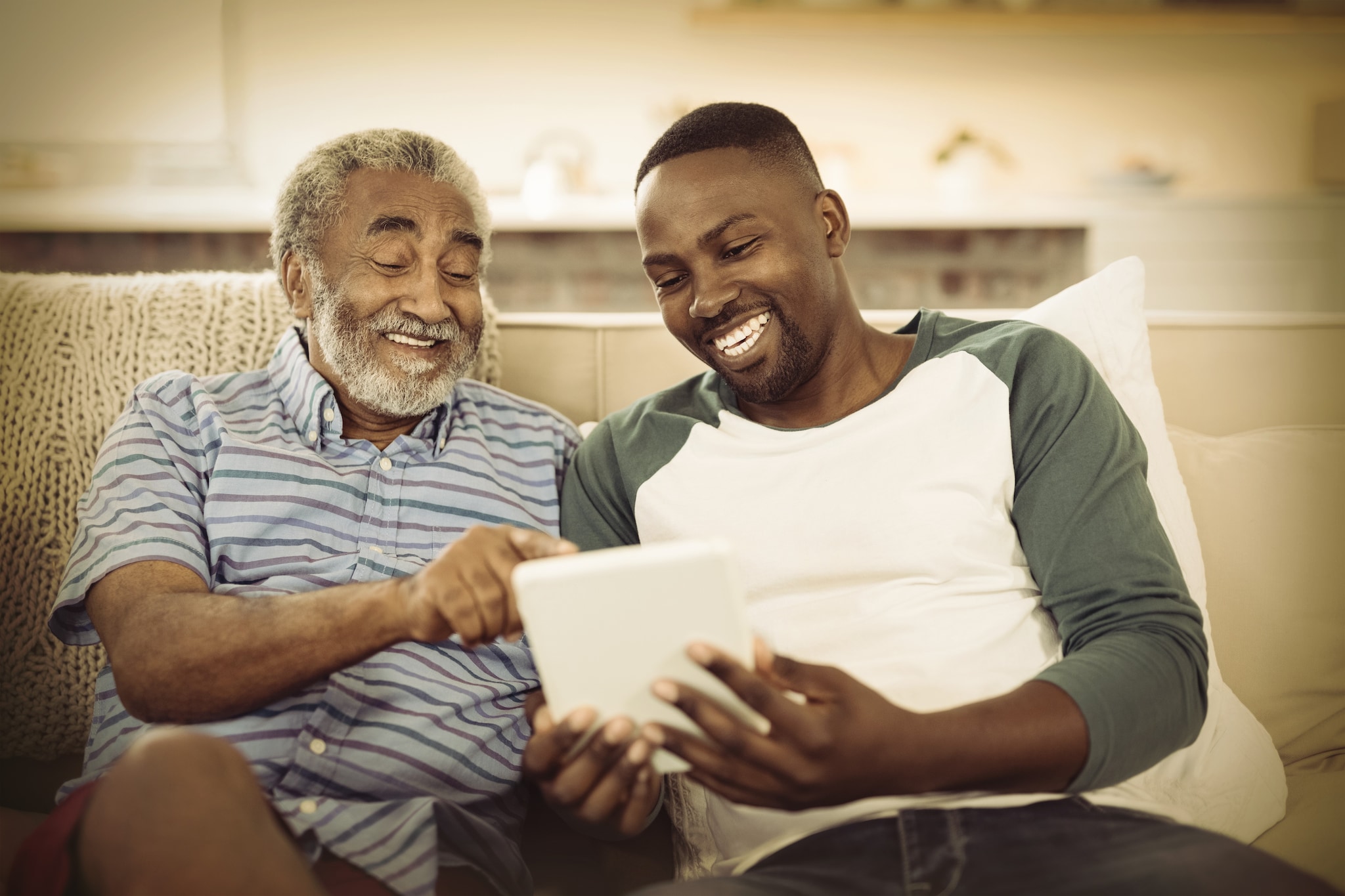 Grandson & Grandparent sitting together laughing Grandson & Grandparent sitting together laughing