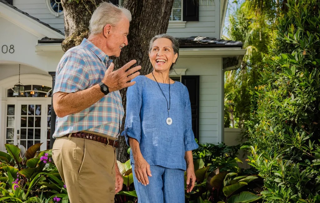 Senior walking wearing ADT's medical alert pendant