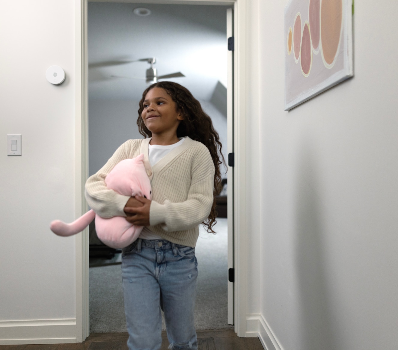 Child walking into her house with an ADT Indoor Siren on the wall Child walking into her house with an ADT Indoor Siren on the wall