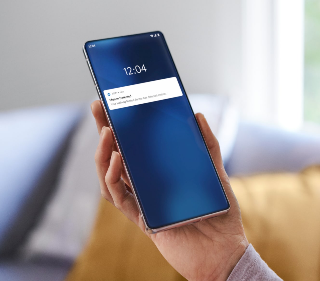 Someone holding a phone showing notifications from the ADT app Someone holding a phone showing notifications from the ADT app