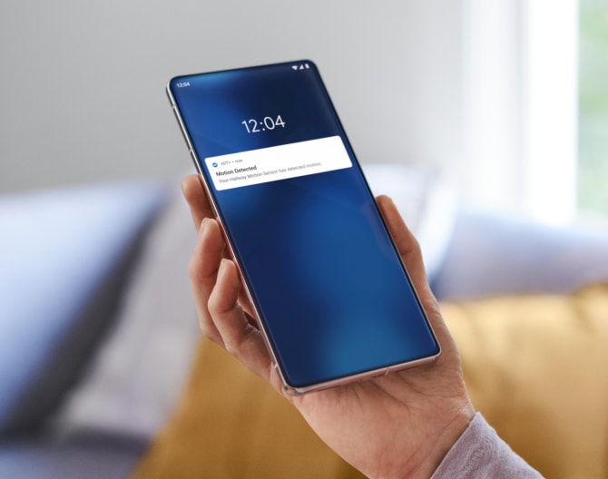 Someone holding a phone showing notifications from the ADT app Someone holding a phone showing notifications from the ADT app
