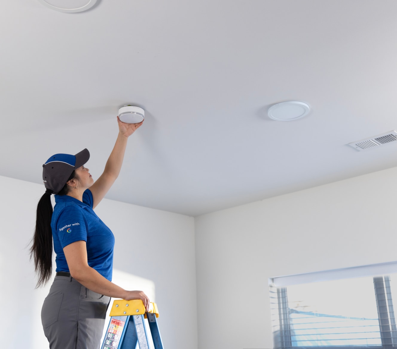 ADT employee installing an ADT Battery Smoke Detector ADT employee installing an ADT Battery Smoke Detector