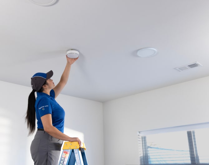 ADT employee installing an ADT Battery Smoke Detector ADT employee installing an ADT Battery Smoke Detector