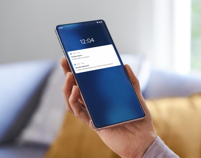 Hand holding a phone with notifications coming through Hand holding a phone with notifications coming through