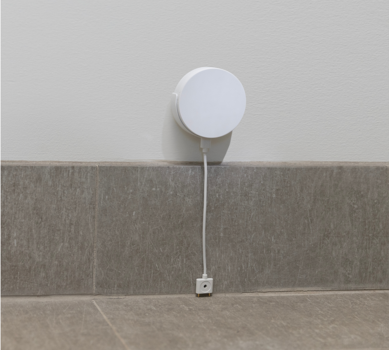 Water & Temperature Sensor installed above baseboard in a home Water & Temperature Sensor installed above baseboard in a home